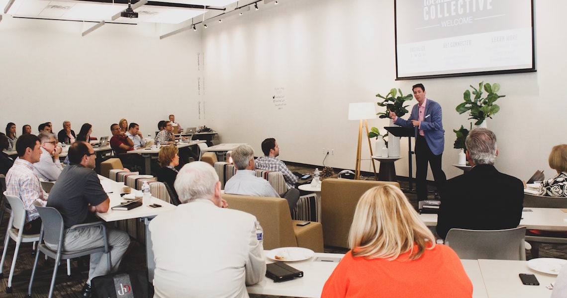 Large meeting and facilitator in meeting venue