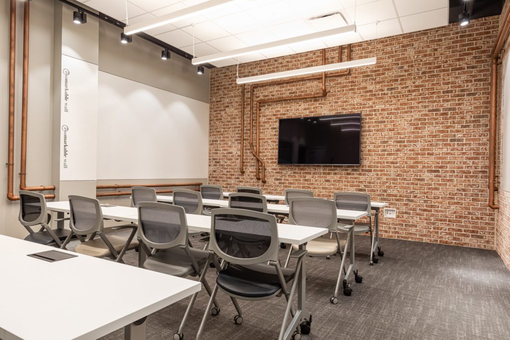 Meeting room seating up to 16 people in Buckhead with exposed brick