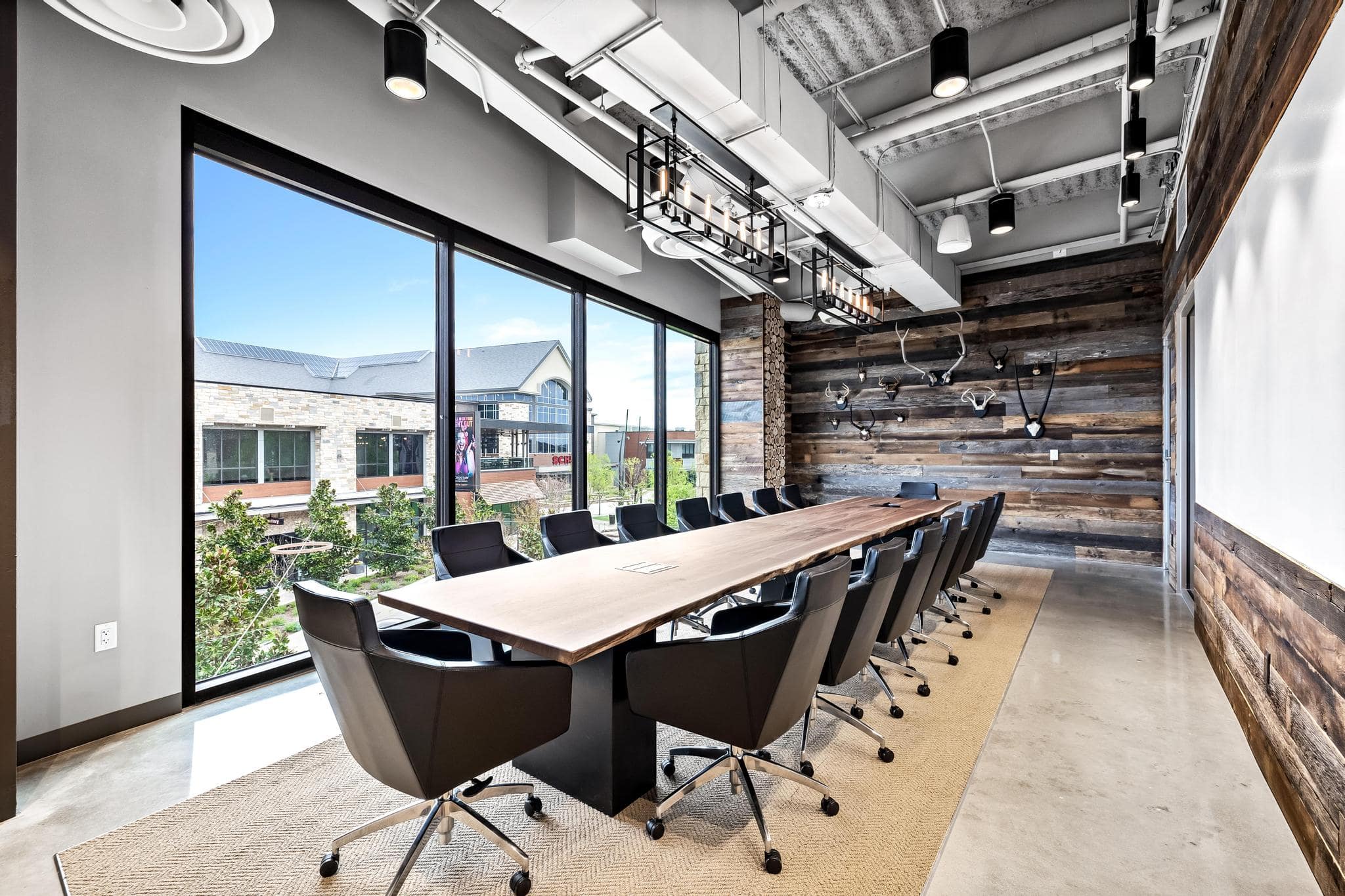 Luxury boardroom seating 16 people with floor-to-ceiling windows at Roam Grandscape