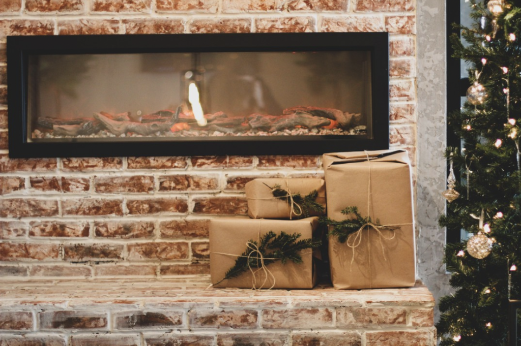 christmas decorations at roam, presents by a fire place