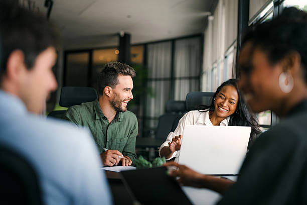 group of people laughing in office